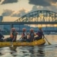 a dynamic urban scene capturing rafters in modern gear attentively discussing essential safety tips while surrounded by the architectural backdrop of chattanooga's skyline.